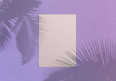 Blank white vertical paper sheet 5x7 inches on violet background with shadow overlay. Modern and stylish greeting card or wedding invitation mock upの写真素材