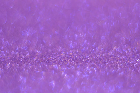 Glitter background pink, de-focused, macro. Sparks fall and sparkle. Pink bokeh background.