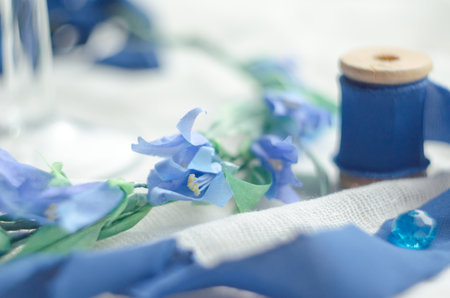 Wedding blue decor with silk ribbon, bride wreath and crystals. Free space. Soft focusの写真素材