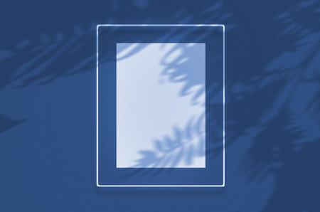 Mockup poster in a neon frame with glow. Scene on wall with tropical overlay palm shadows with free...