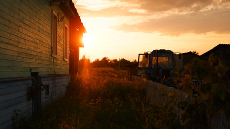 Rural landscape with field at sunset and village in the background. Vologda region.の写真素材
