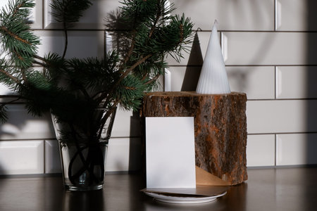 Christmas Ecological Mockup Card In Scandinavian Style. Blank greeting card with Christmas decorations on wooden table in modern roomの写真素材