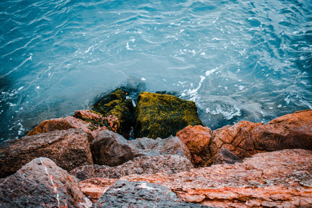 Close up water with stones on the beach concept photo. Underwater rock. Mediterranean winter sea....