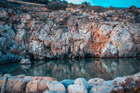 Amazing panoramic landscape of rocky shore photo. Mediterranean sea, Catalonia. Water with stones on the beach concept photo. The view from the top, nautical background. High quality picture for wallpaperの写真素材