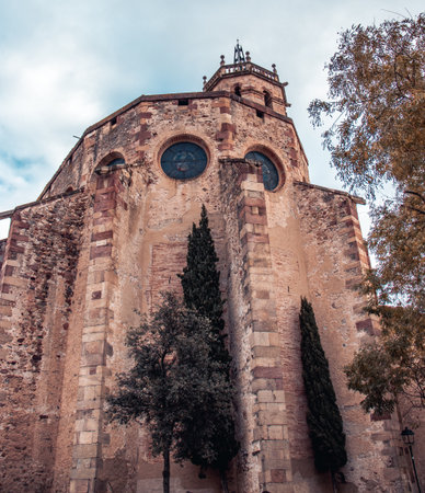 St Mary Church in Catalonia photo. Romanesque architecture in Caldes de Montbui, Barcelona Province. Street scene. High quality picture for wallpaper, articleの写真素材