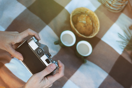 Womens hands take picnic outdoors pictures with cameraの写真素材
