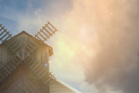 Mill on the background of a beautiful sky with clouds, place for textの写真素材
