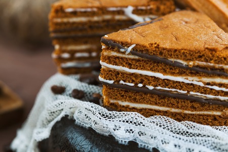 tender cake with coffee beans on a gray wooden background. Selective focus, close up. background for postcardの写真素材