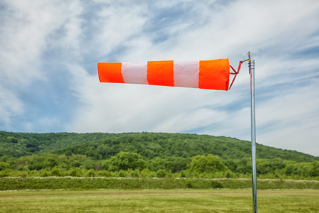 red and white wind sock on blue sky, mounting and clouds background Close-upの写真素材