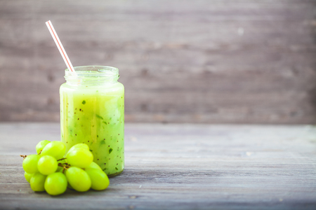 freshly squeezed fruit juice, smoothies greengrape strawberry on a dark wooden background Copy space.の写真素材