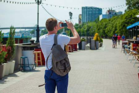 Russia Rostov-on-Don June 16, 2018 guy tourist takes pictures on the phone and walks around the city, where the World Cup 2018.のeditorial素材
