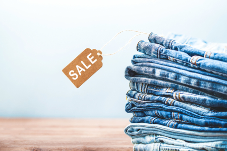 Concept sales, blue jeans on a light background Copyspace. Concept sales, blue jeans on a light background Copyspace.
