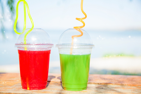 Bright Fresh healthy juices on the background of the sea. Summer, rest, healthy lifestyle Copy spaceの写真素材