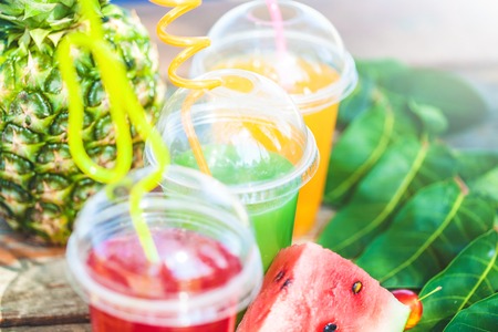 Fresh healthy juices, fruit, pineapple, watermelon on the background of the sea. Summer, rest, healthy lifestyle Copyspaceの写真素材