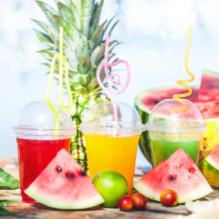 Bright Fresh healthy juices, fruit, pineapple, watermelon on the background of the sea. Summer, rest, healthy lifestyle Close-upの写真素材