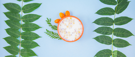 morning breakfast, muesli, fruit, peaches on a blue background with green leaves Healthy breakfast freshness Flat lay Top view Banner concept Copyspaceの写真素材