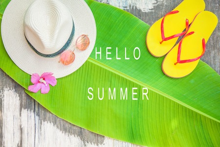 Palm leaf Straw hat Pink sunglasses Beach flip-flops Summer background Top viewの写真素材
