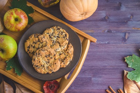 Autumn background. Cookies, Pumpkin Leaves Apples on a wooden backgroundの写真素材