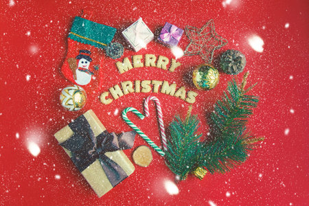 Christmas and New year concept. On a red background gift boxes, Christmas candy, decor . Cookies...