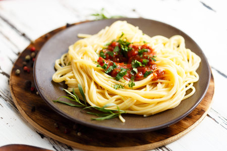 Plate with pasta with sauce. Cherry, chilli, tomato, basil, spices, tarragon, onion Ingredients for cooking pasta Menu and restaurant concept