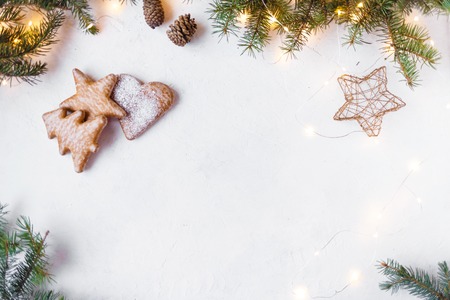 New Year and Christmas concept. Christmas tree, Christmas decorations, cookies, festoon on a light background Copy space Top viewの写真素材