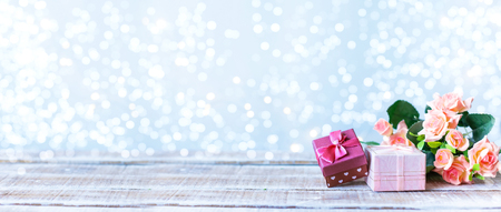 Boxes with gifts, a bouquet of flowers on a light blue background with bokeh. Women's Day, Mother's Day Concept Copy spaceの写真素材