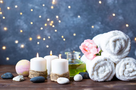 Spa, beauty treatment and wellness background Towel Cosmetic Massage oil, flowers and burning...
