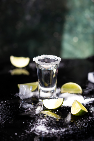 Tequila shot with lime and salt on black background Copy spaceの写真素材