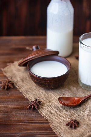 Homemade yogurt in a cup, a glass of kefir with probiotics Probiotic cold fermented dairy drink Trendy food and drink Copy space Rustic style.の写真素材