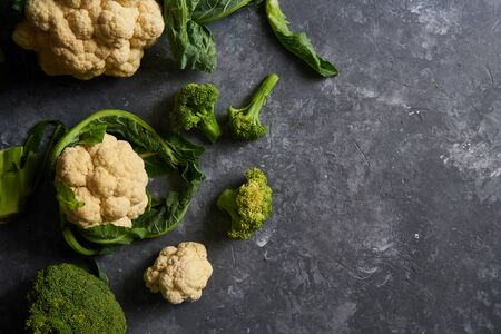 Organic cauliflower and broccoli on a plate on a dark background Copy spaceの写真素材
