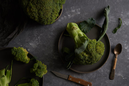 Organic broccoli on a plate on a dark background Copy space Top view