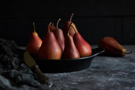 organic pears in a plate on a dark background Close upの写真素材