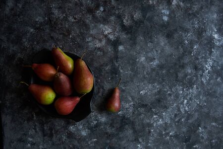 organic pears in a plate on a dark background Copy space Top viewの写真素材