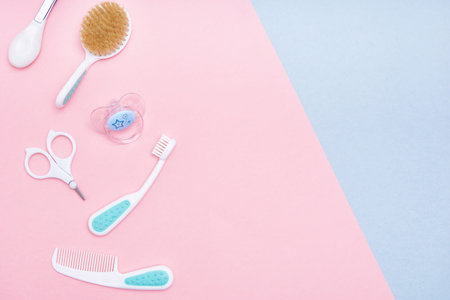 Baby accessories on pink and blue background. Flat lay . Top view Copy space.