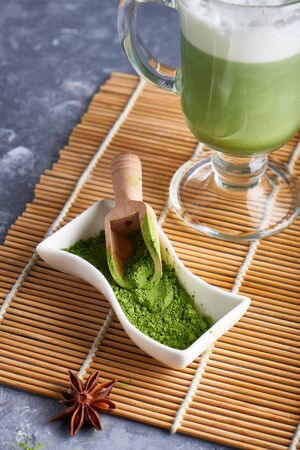 Creen tea Matcha powder in bowl and Matcha Latte on gray background Verticalの写真素材