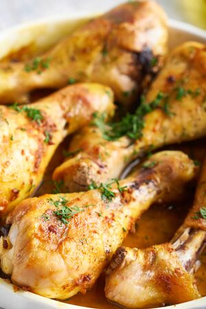 Fried chiken drumstick served in white bawl wiht spices, salad and turmeric Vertical Close upの写真素材