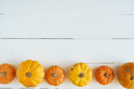 Autumn background of pumpkins on a wooden table. Halloween concept Vintage Top viewの写真素材