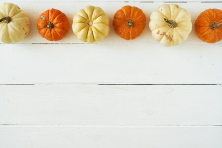 Autumn background of pumpkins on a wooden table. Halloween concept Vintage Top viewの写真素材