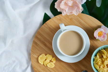 White cup of coffee latte on exotic background. Breakfast concept Top view Copy space