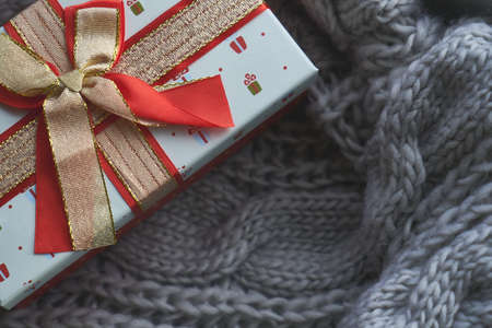 Christmas gifts on knitted gray blanket Close upの写真素材