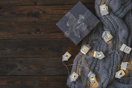 Christmas gifts and garlands on knitted gray blanket Close upの写真素材