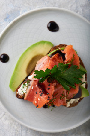 Tasty homemade sandwich with salmon ,greens and avocado