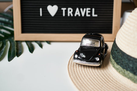 Travel concept. toy car, hat, letter board with inscription I love Travel on the white backgroundの写真素材