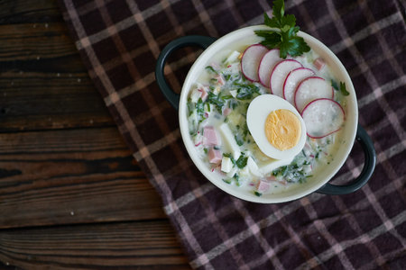Traditional Russian cold okroshka soup served in a plate with herbs Kefir vegetable soupの写真素材