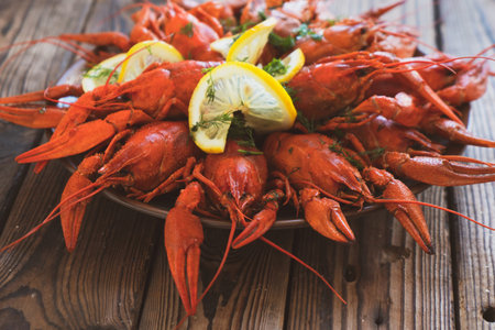 boiled crayfish served on a platter with herbs and lemon