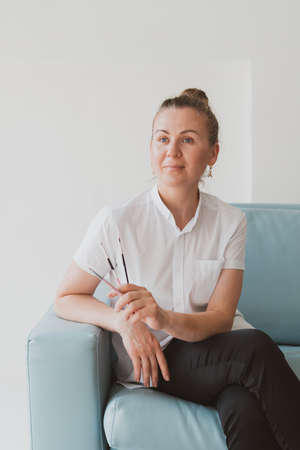 Portrait of doctor beautician , make-up master sits on a chairの写真素材