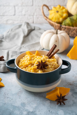 rice porridge with pumpkin cooked with vanilla and spices. Served in a beautiful dishの写真素材