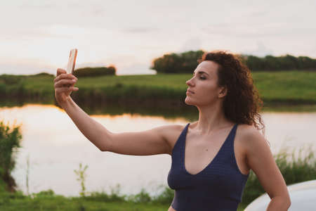 Young woman travelers are photographed on a smartphone in natureの写真素材
