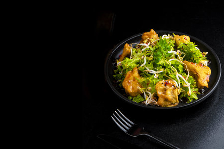 traditional asian food on plate on black backgroundの写真素材