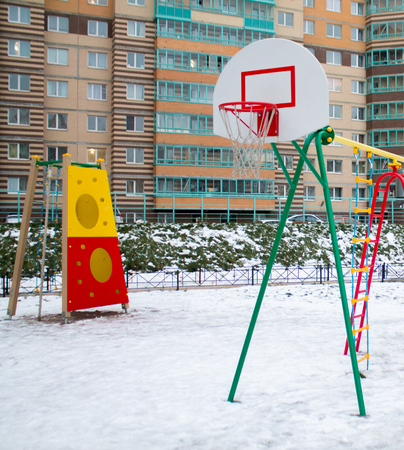 children's playground in the front of the house in the winterの写真素材